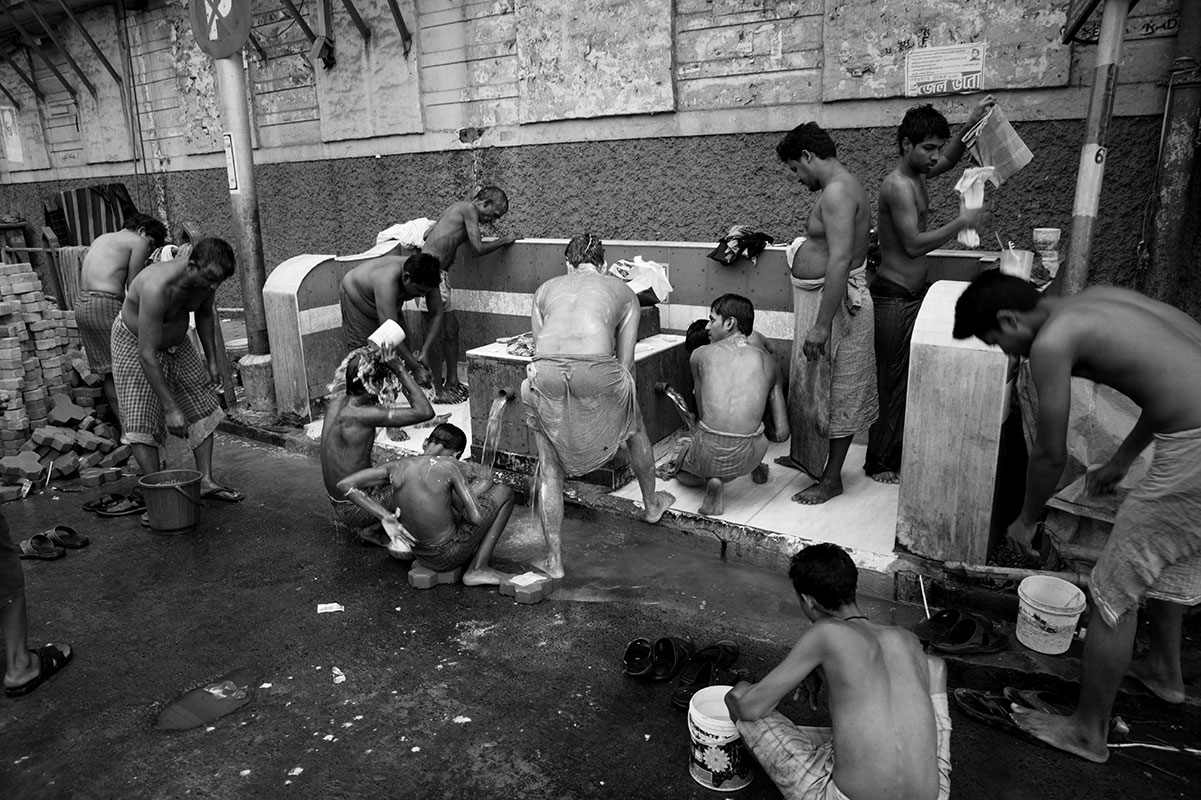 Men wash at public baths in Northern Indian street
