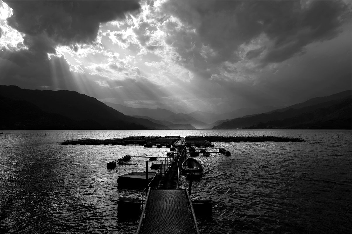 Storm clouds gather over Pokhara lake