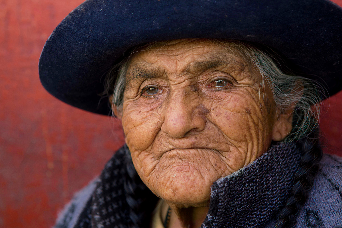 Market seller in bowler hat in Cusco