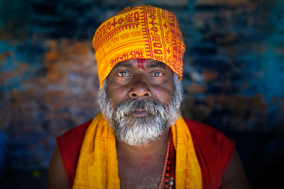 Sadhu in orange sitting in ashram, sadhu project photography