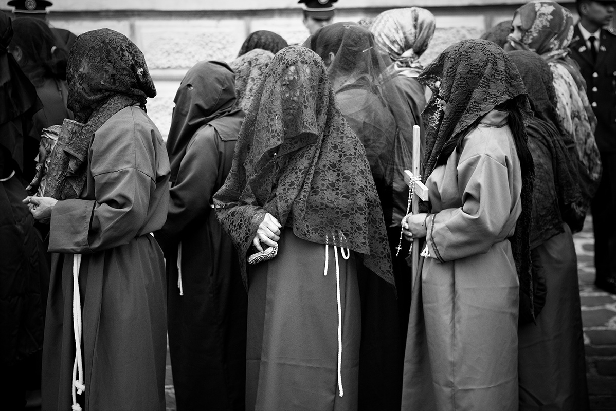 Widower stares from under veil