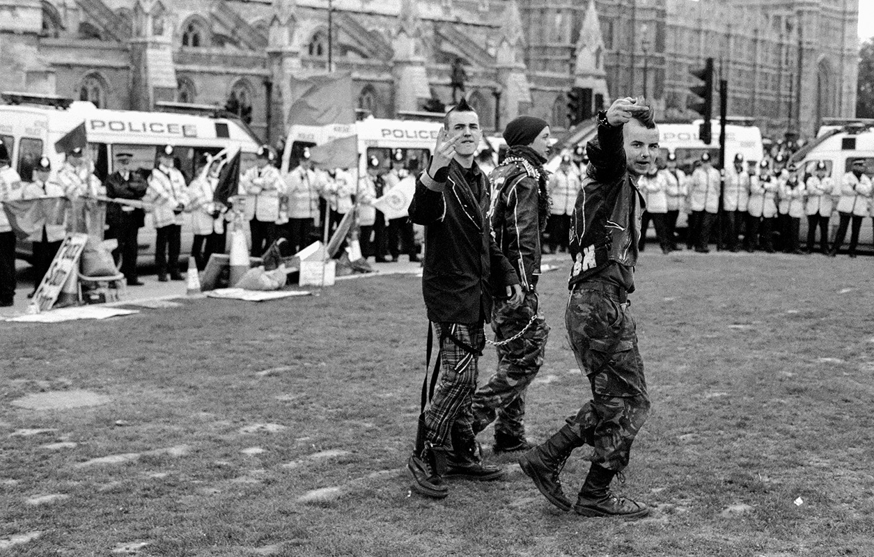Punk rockers portray aggression in front of police in Westminster