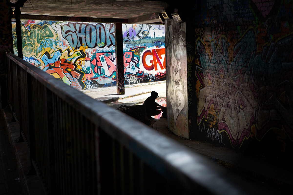 Solo graffiti artist tags wall in Leake St, Waterloo