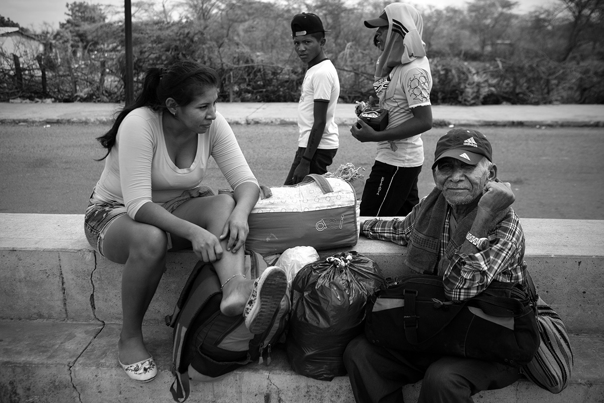 Old and young man stare at British photographer