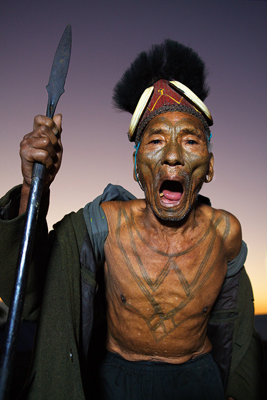 Warrior with facial tattoo sings with spear