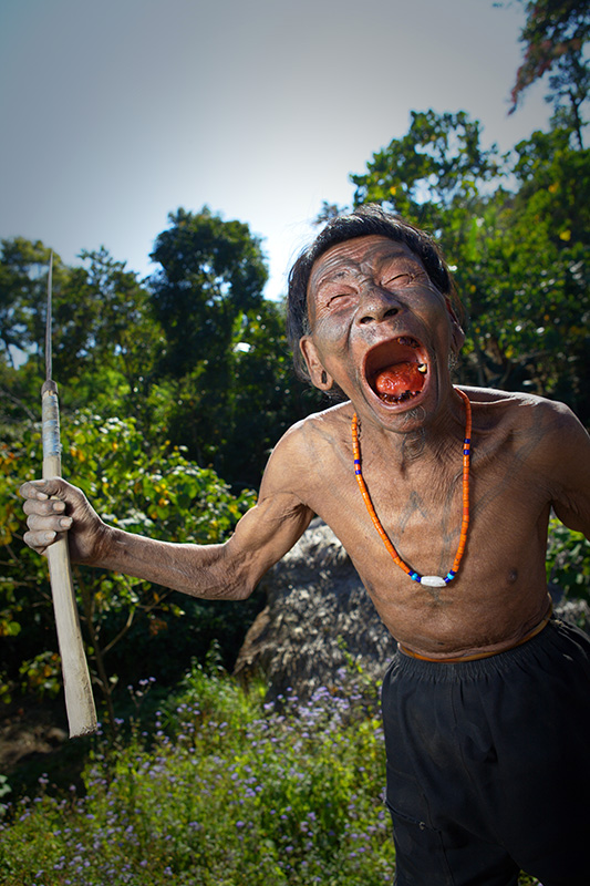 Aggressive Konyak tribesman brandishes machete